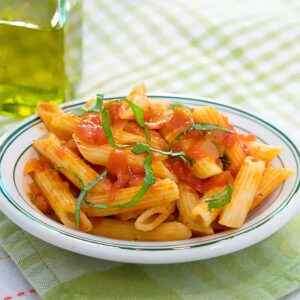 Pasta Arrabiata is a classic combination of pasta and bacon with red pepper flakes and basil. Best part? It's ready in under 30 minutes! https://www.lanascooking.com/pasta-arrabiata/
