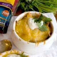 Chicken Tortilla Onion Soup - My Mexican riff on onion soup - with tortilla strips, chicken, onions, and poblano peppers - topped with a Mexican cheese blend. https://www.lanascooking.com/chicken-tortilla-onion-soup/