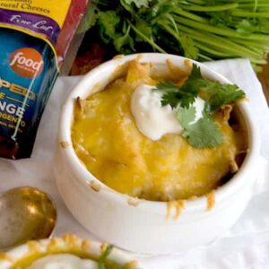 Chicken Tortilla Onion Soup - My Mexican riff on onion soup - with tortilla strips, chicken, onions, and poblano peppers - topped with a Mexican cheese blend. https://www.lanascooking.com/chicken-tortilla-onion-soup/