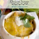 Chicken Tortilla Onion Soup - My Mexican riff on onion soup - with tortilla strips, chicken, onions, and poblano peppers - topped with a Mexican cheese blend. https://www.lanascooking.com/chicken-tortilla-onion-soup/