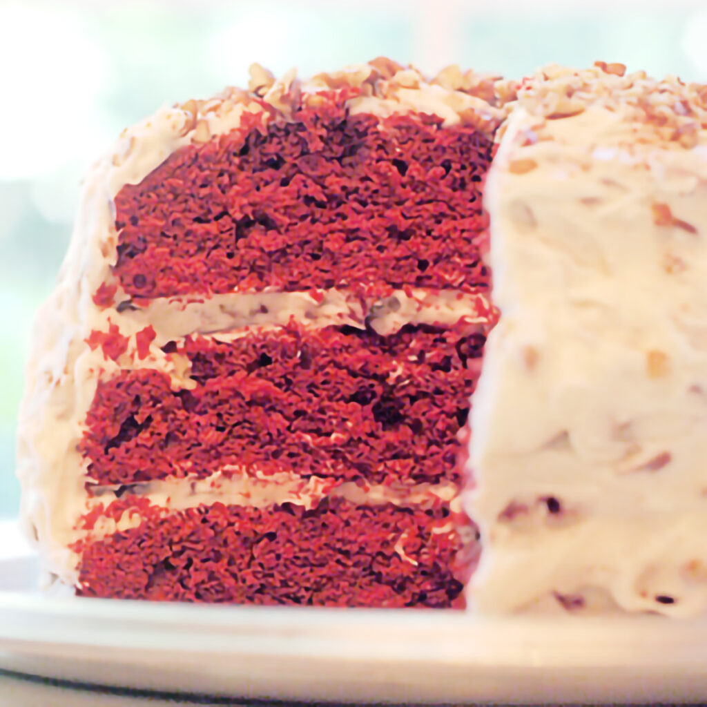 Finished red velvet cake on a cakeplate.
