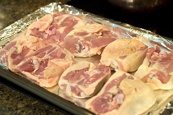 Chicken thighs on baking sheet lined with foil