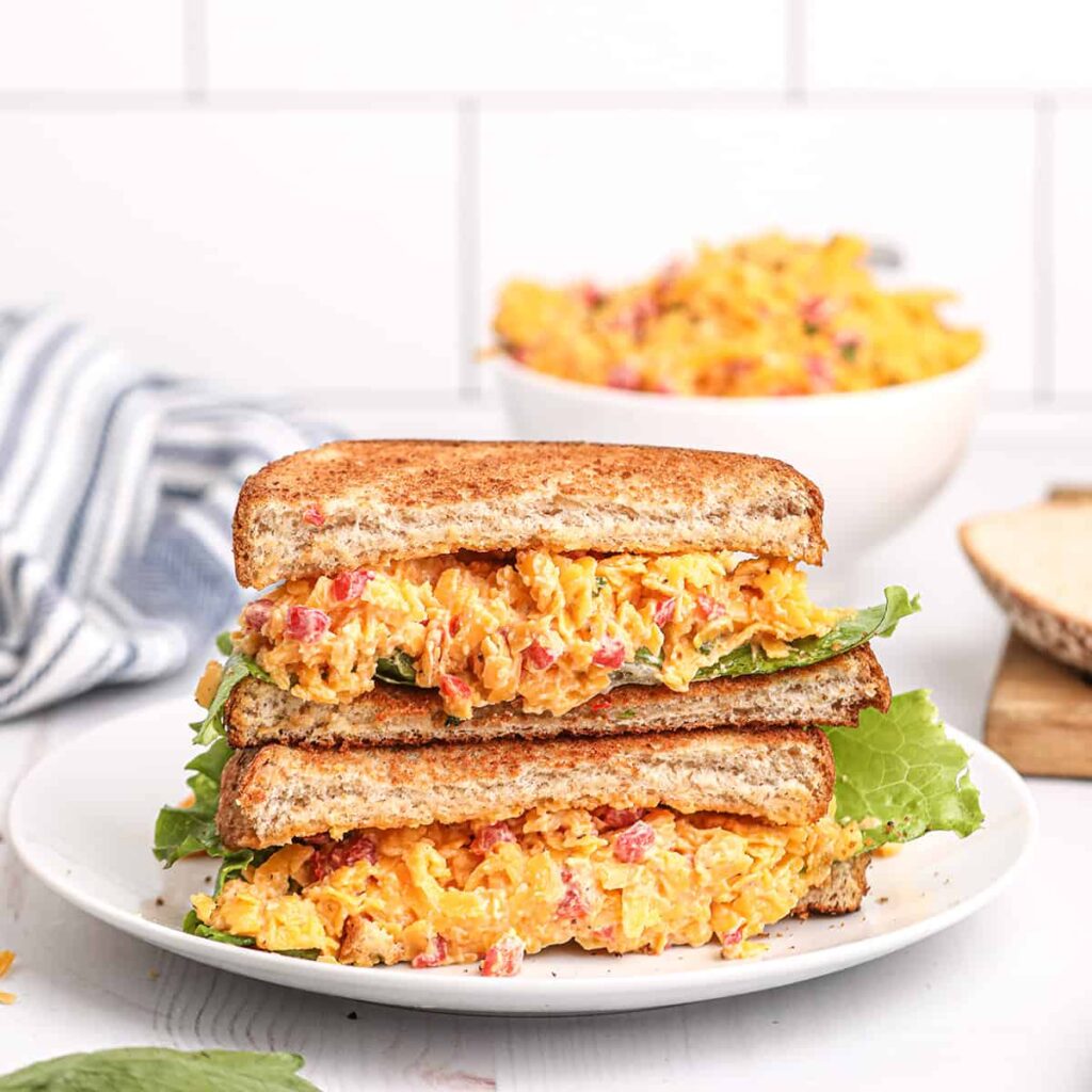 Pimiento cheese sandwich on a white serving plate.