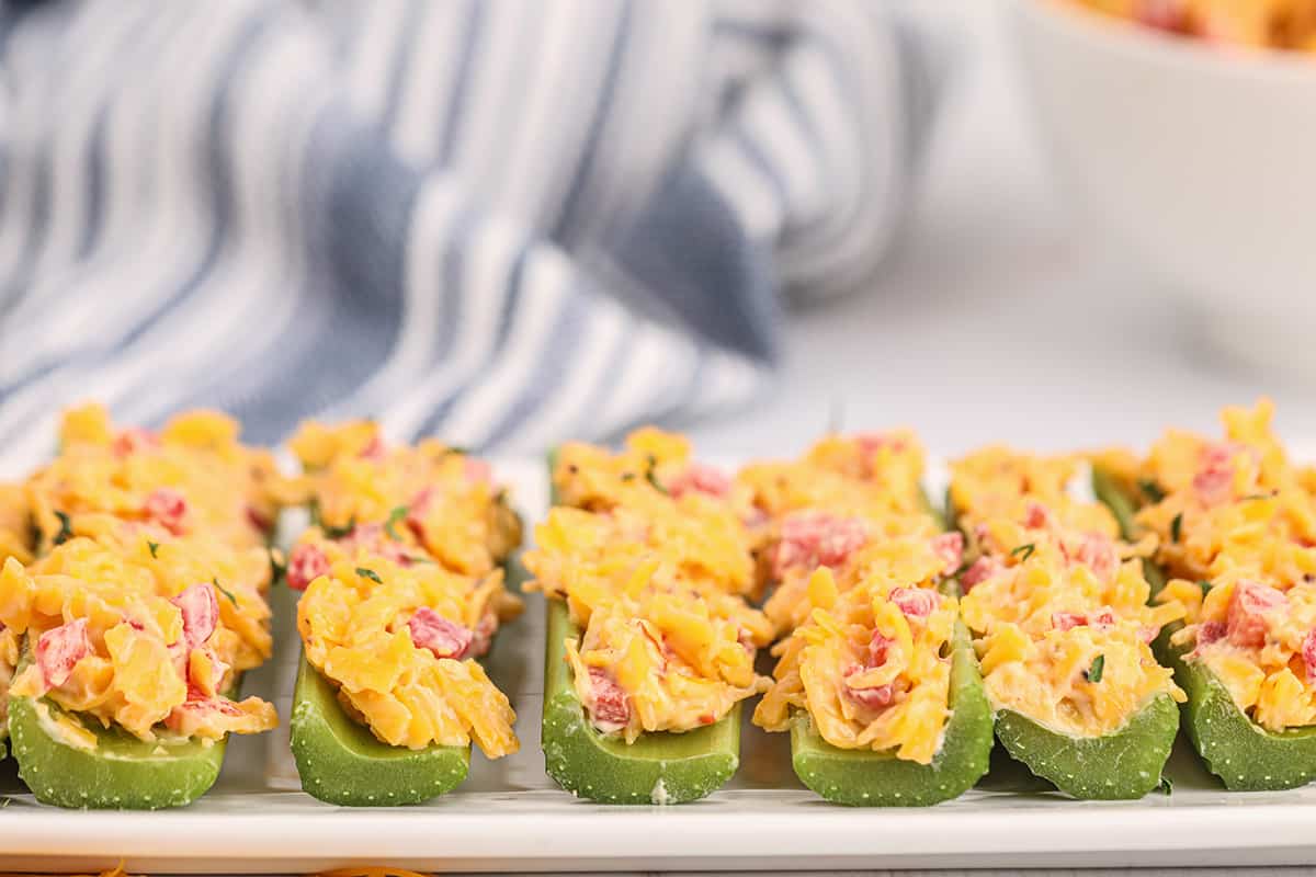 Pimiento cheese stuffed celery sticks on a serving plate.