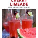 Two glasses of watermelon cherry limeade with straws, garnished with cherries and lime, beside fresh watermelon.