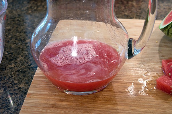 Watermelon juice in a glass pitcher.