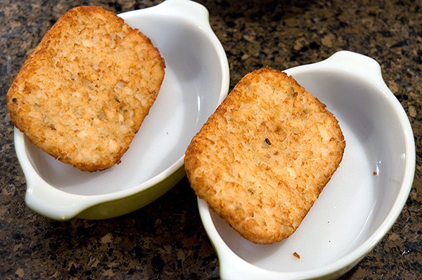 Toasted hash brown patties in individual serving bowls.