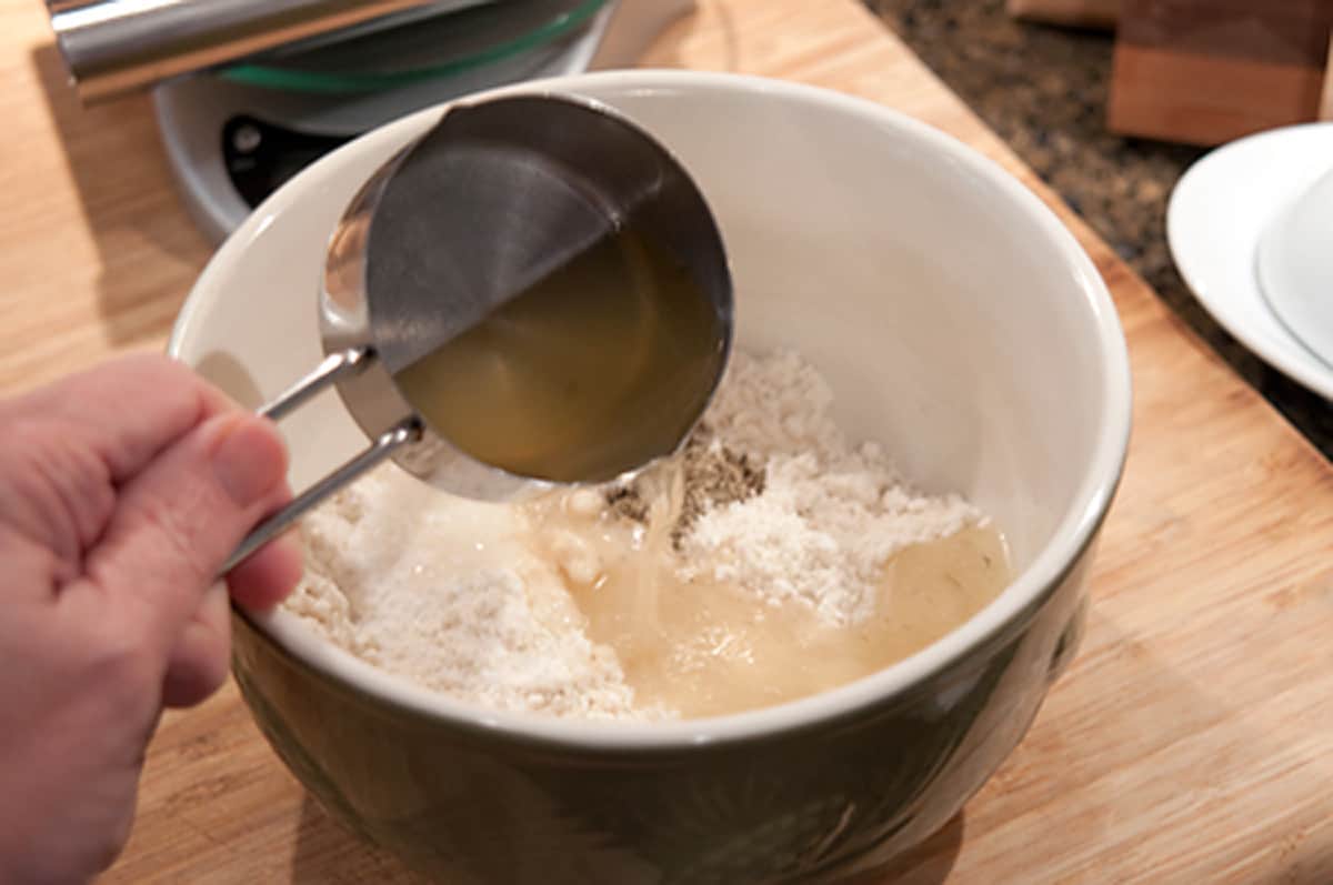 Adding pot likker to the cornmeal.