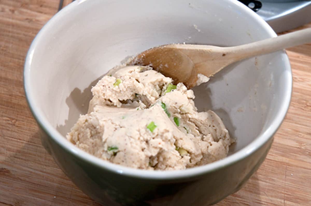 Mixing dough in a bowl.