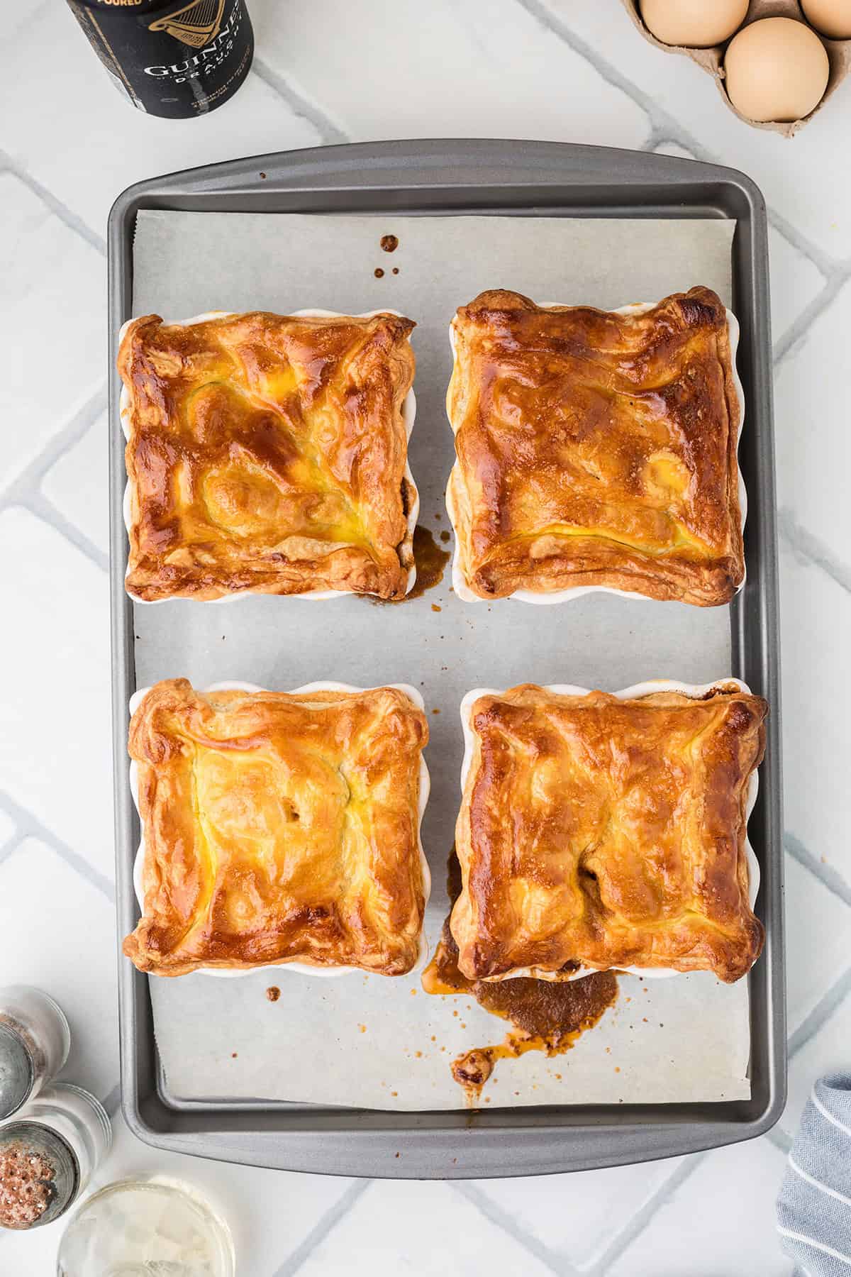 Golden brown baked pies on a sheet.