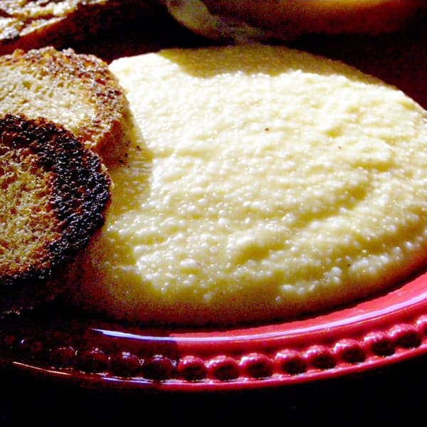 Classic southern Cheese Grits go with any meal from breakfast to supper and are always the answer to the dilemma of which side dish to serve. https://www.lanascooking.com/cheese-grits/
