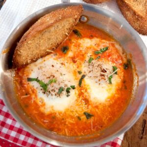 Eggs in Purgatory - Eggs poached in a quickly made tomato, garlic, and basil sauce. Perfect supper for one or late night indulgence. https://www.lanascooking.com/eggs-in-purgatory/
