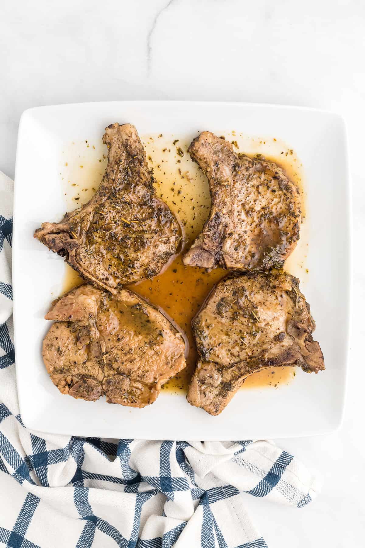Pork chops and sauce on a serving plate.