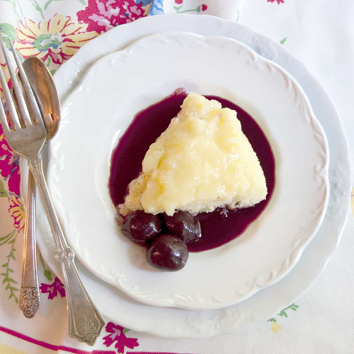 Lemon Pudding Cake with Cherry Coulis - a vintage recipe for lemon pudding cake in which the mixture separates into layers while baking! https://www.lanascooking.com/lemon-pudding-cake-with-cherry-coulis/