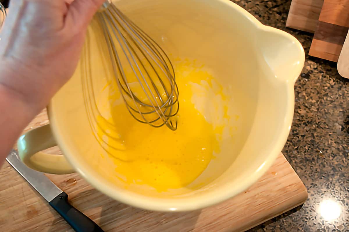 Beaten egg yolks in mixing bowl