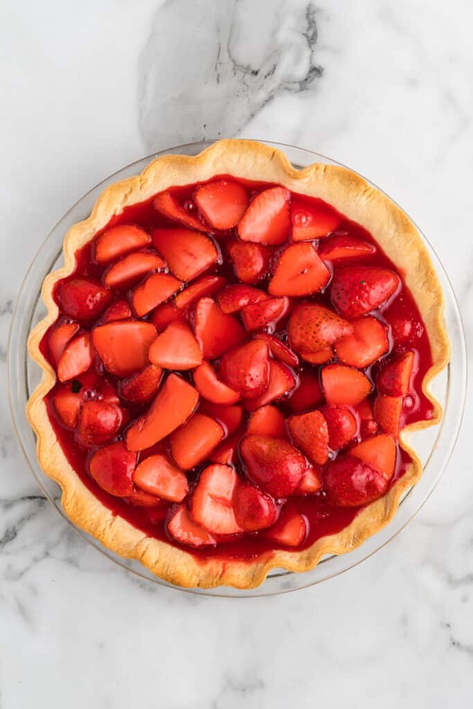 Strawberry filling added to baked pie crust.
