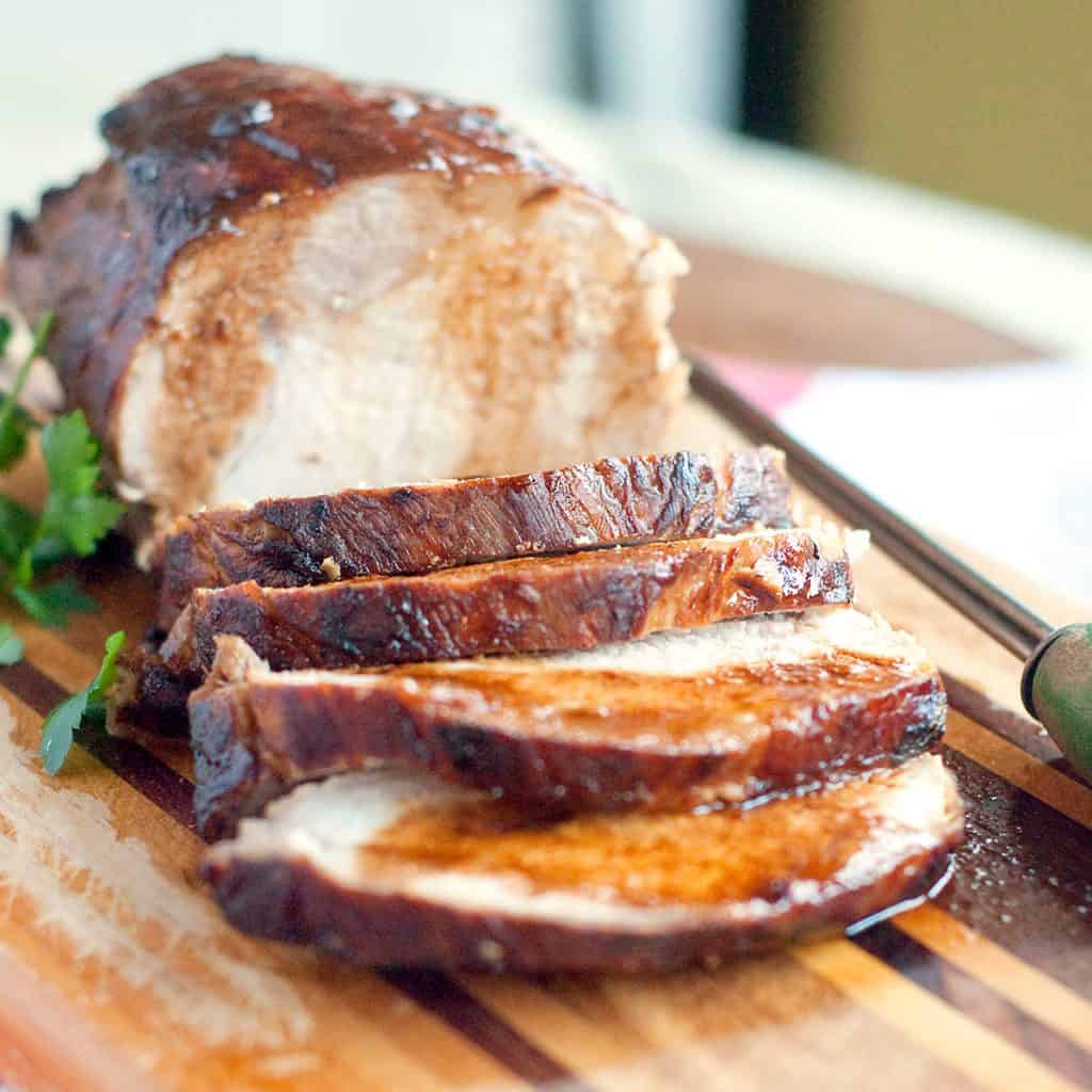 Sliced pork loin on a serving board.