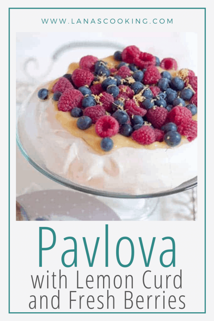 Pavlova with Lemon Curd and Fresh Berries - this light, crispy meringue topped with lemon curd and berries is the perfect dessert for a spring dinner. https://www.lanascooking.com/pavlova-with-lemon-curd-fresh-berries-giveaway/
