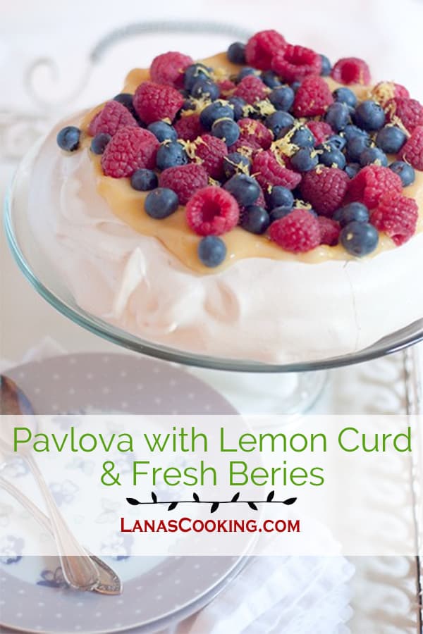 A light, crispy pavlova topped with tangy lemon curd and fresh berries. https://www.lanascooking.com/