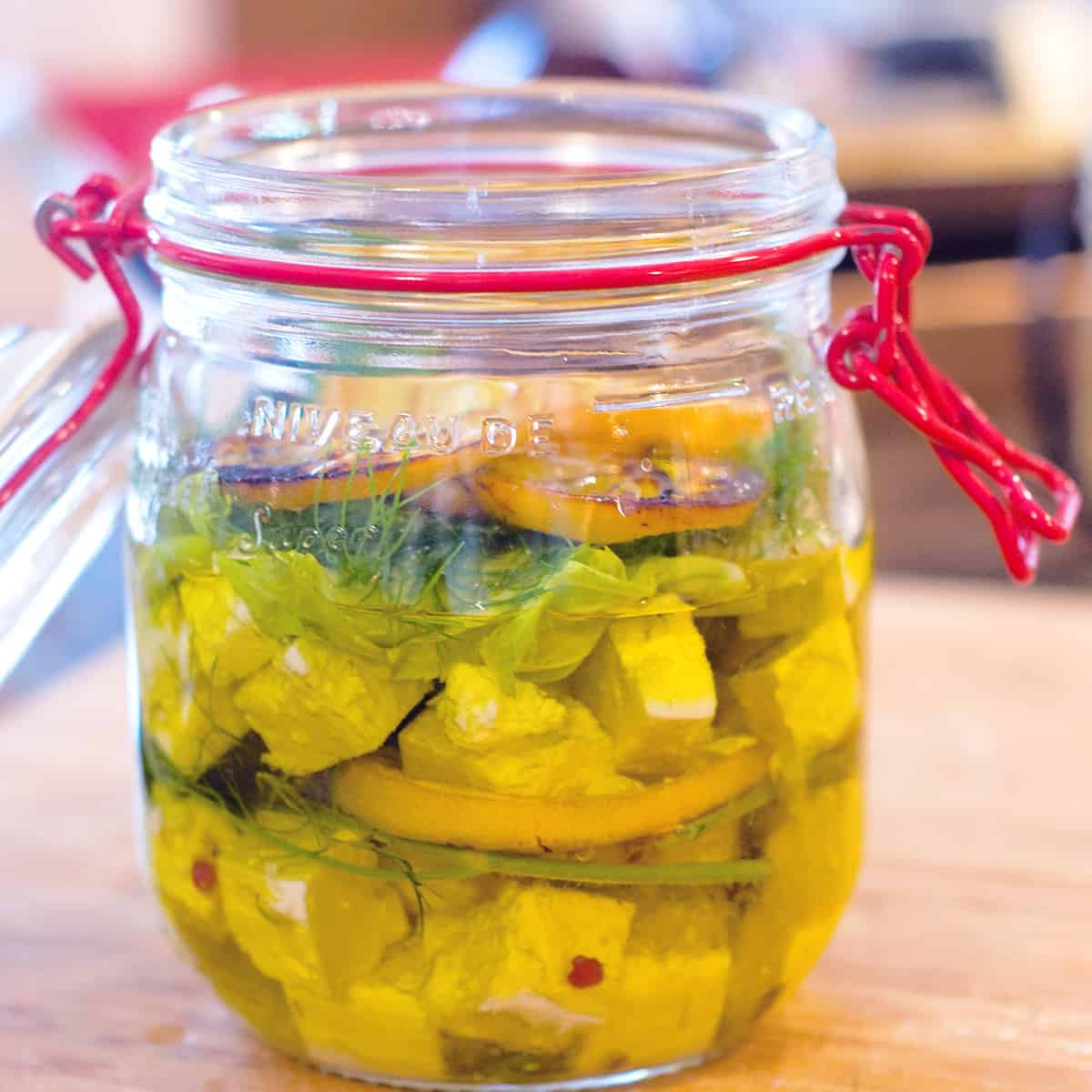 Marinated feta in a glass jar.