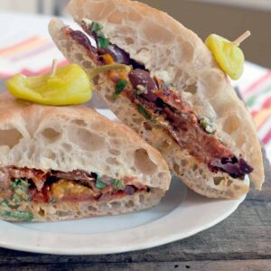 A Roasted Tomato Sandwich on a ciabatta roll layered with a flavored mayonnaise, Kalamata olives, and fresh basil. https://www.lanascooking.com/roasted-tomato-sandwich/