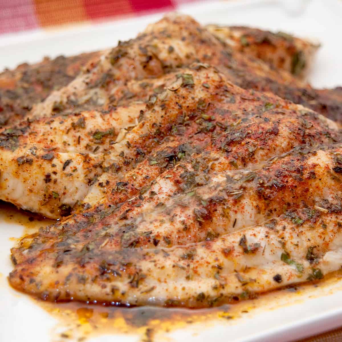 Baked Catfish with Herbs - catfish fillets topped with an herb blend, butter and lemon and baked until golden. Quick and easy weeknight dinner. From @NevrEnoughThyme https://www.lanascooking.com/baked-catfish