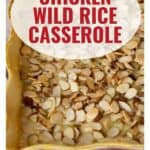 A casserole dish topped with sliced almonds, labeled Chicken Wild Rice Casserole.