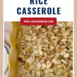 A casserole dish filled with chicken wild rice casserole topped with sliced almonds.
