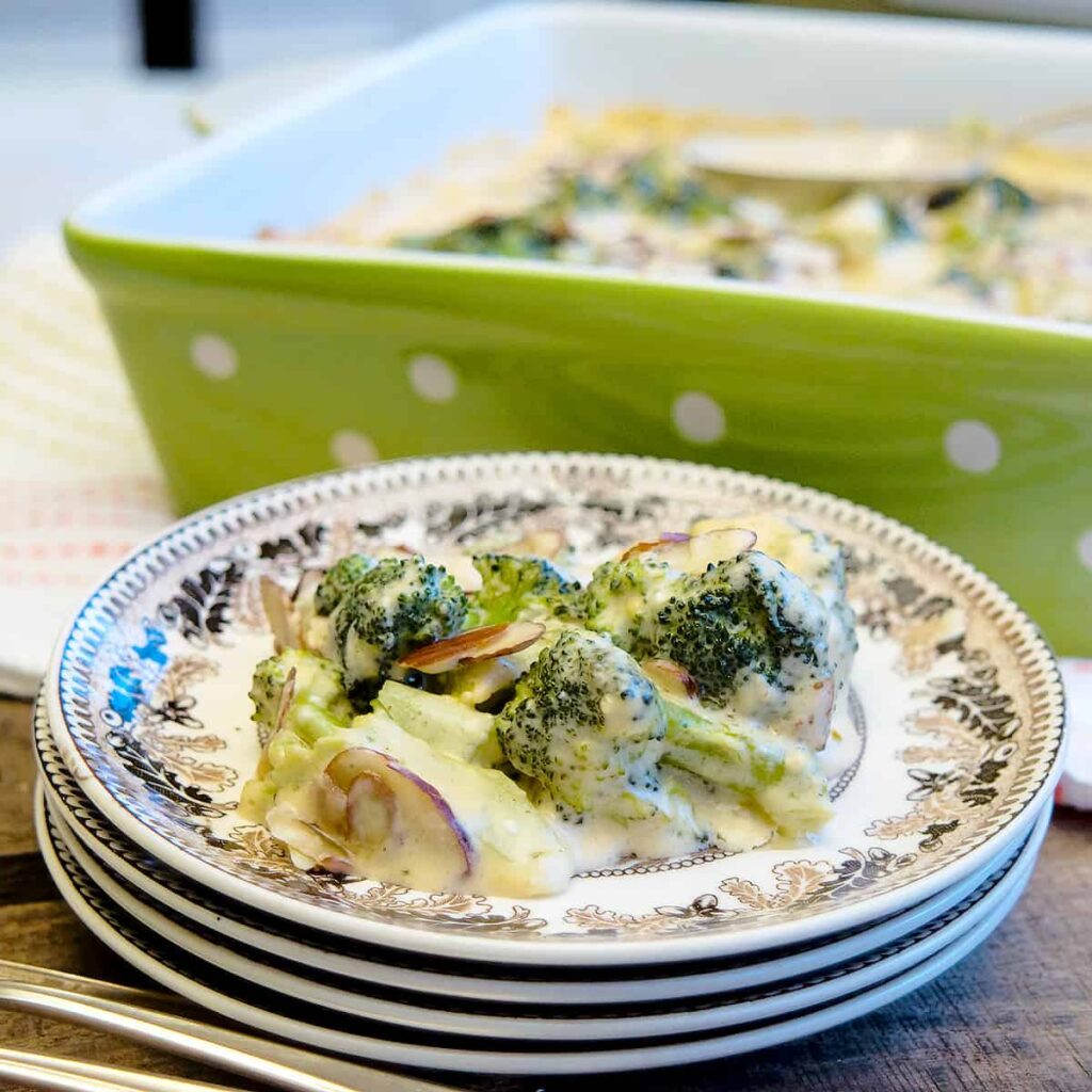 A serving of broccoli casserole on a small decorative plate.