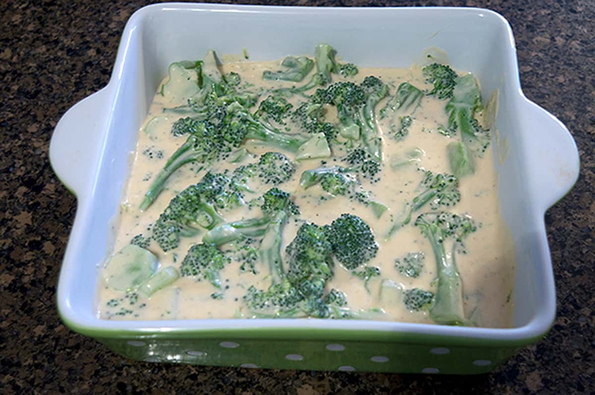 Broccoli and cheese sauce in a casserole dish.