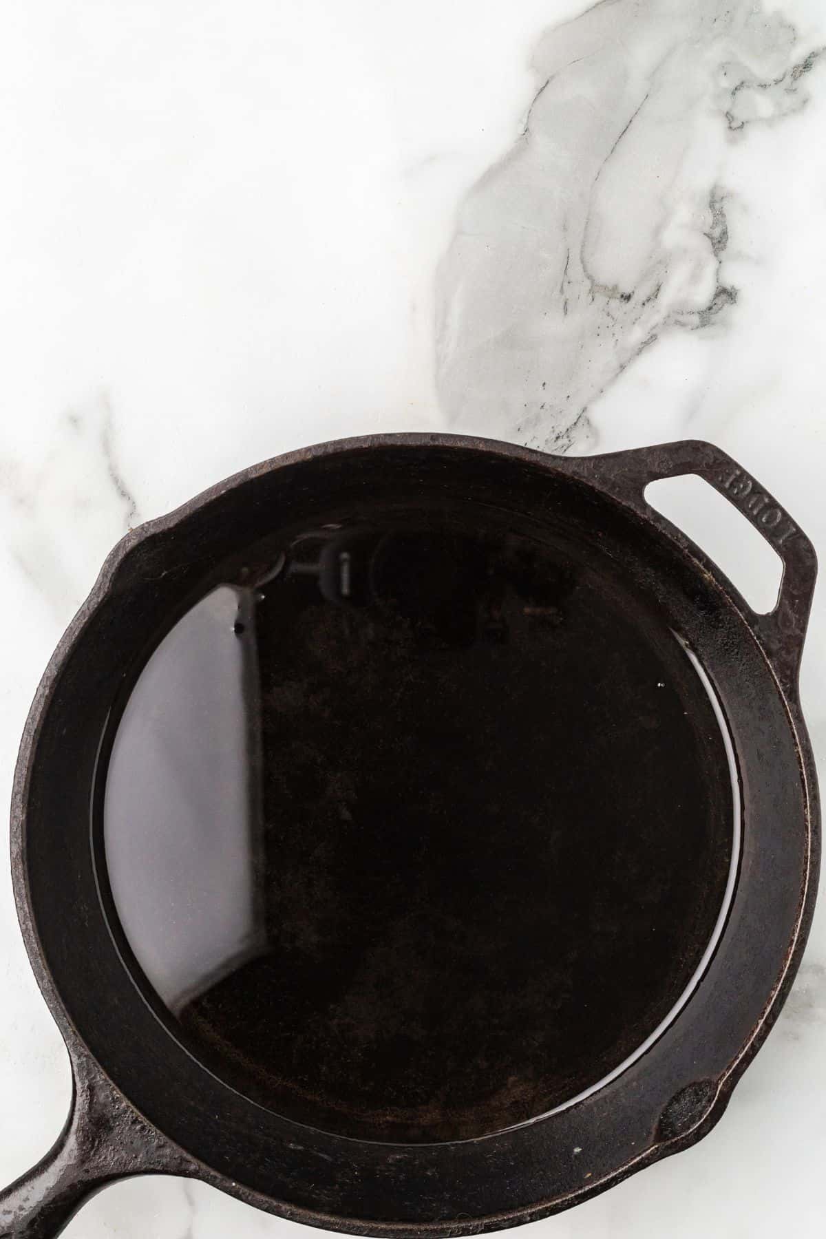 Oil heating in a frying pan.