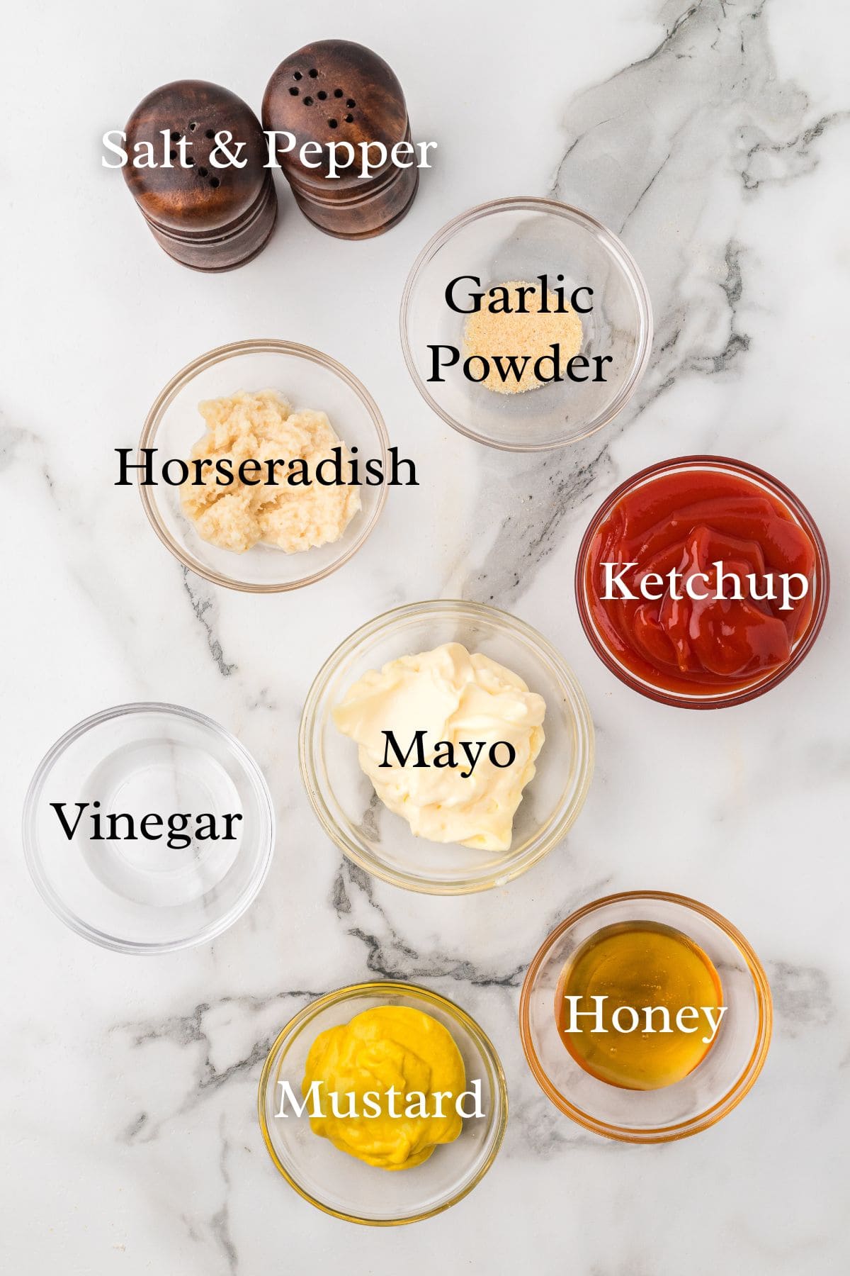 Ingredients for chicken tenders sauces on a marble background.