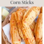 A basket of pimiento cheese corn sticks on a white napkin.