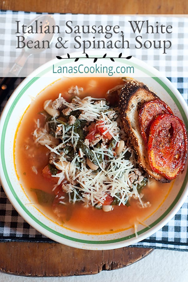 A serving of Italian sausage, white bean, and spinach soup in a bowl on a decorative napkin.