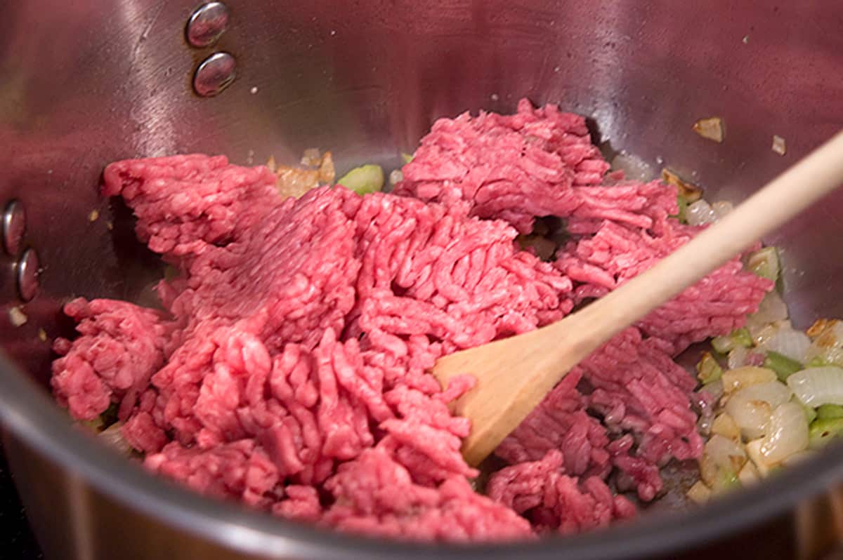 Ground beef added to skillet with onions and celery.