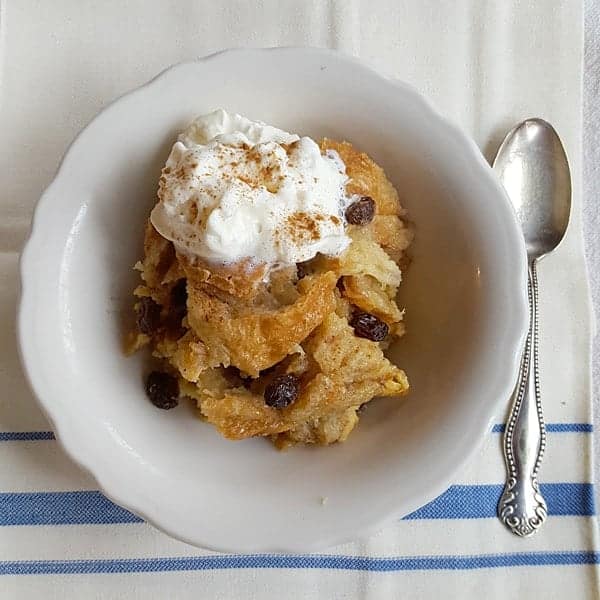 Slow Cooker Bread Pudding - creamy and luscious made with French bread and studded with raisins. https://www.lanascooking.com/slow-cooker-bread-pudding/