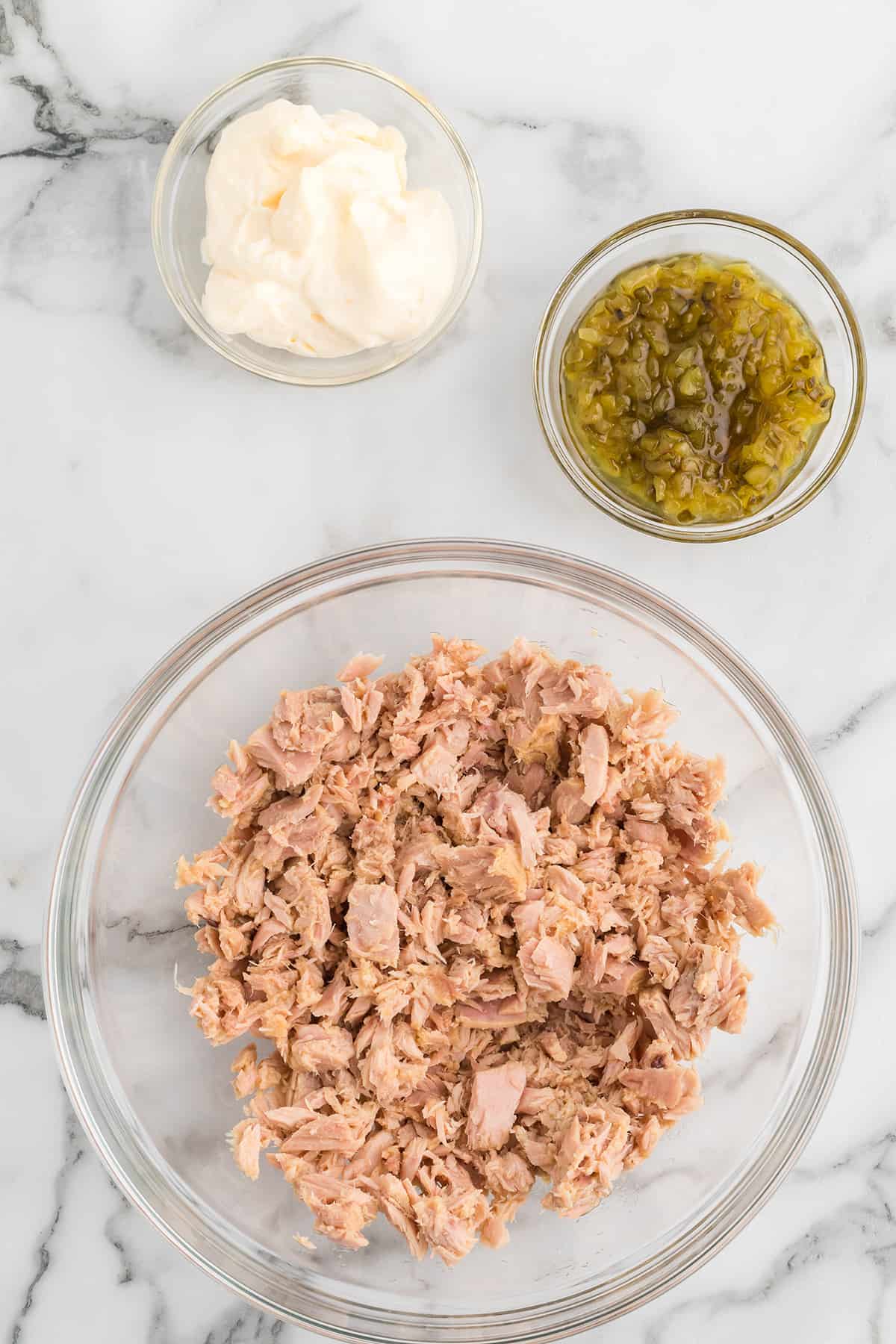 Drained, flaked tuna in a bowl.