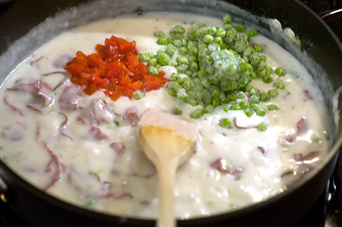 Peas and pimientos added to mixture in skillet.