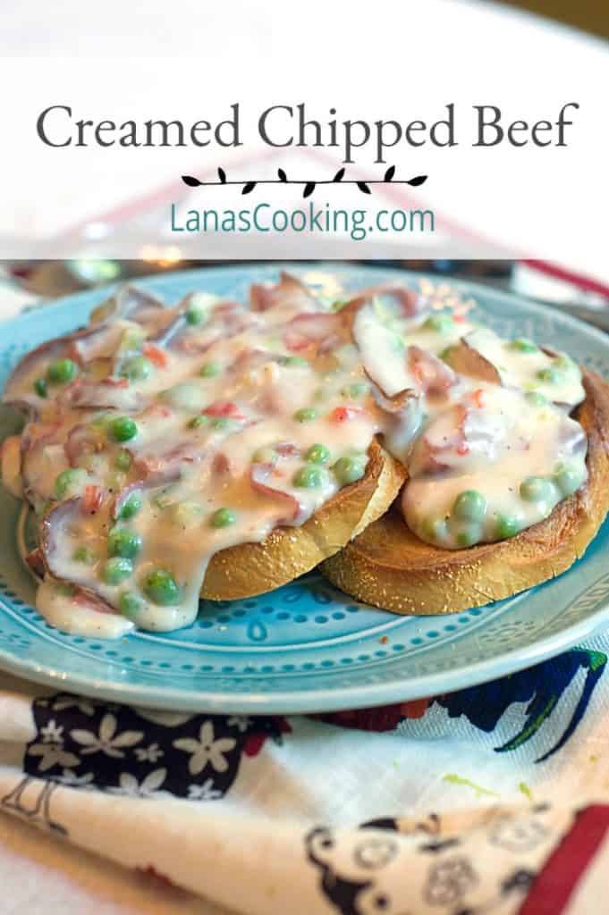 Creamed chipped beef over toast with peas on a blue serving plate.