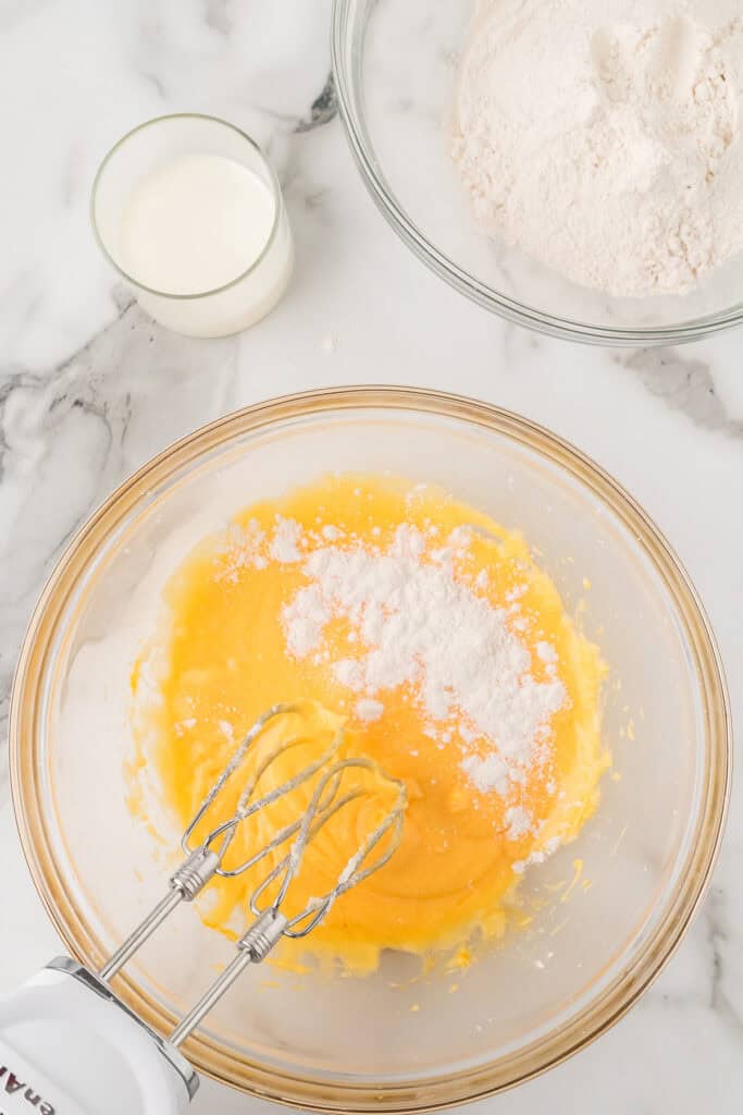 Adding dry ingredients to the wet ingredients.