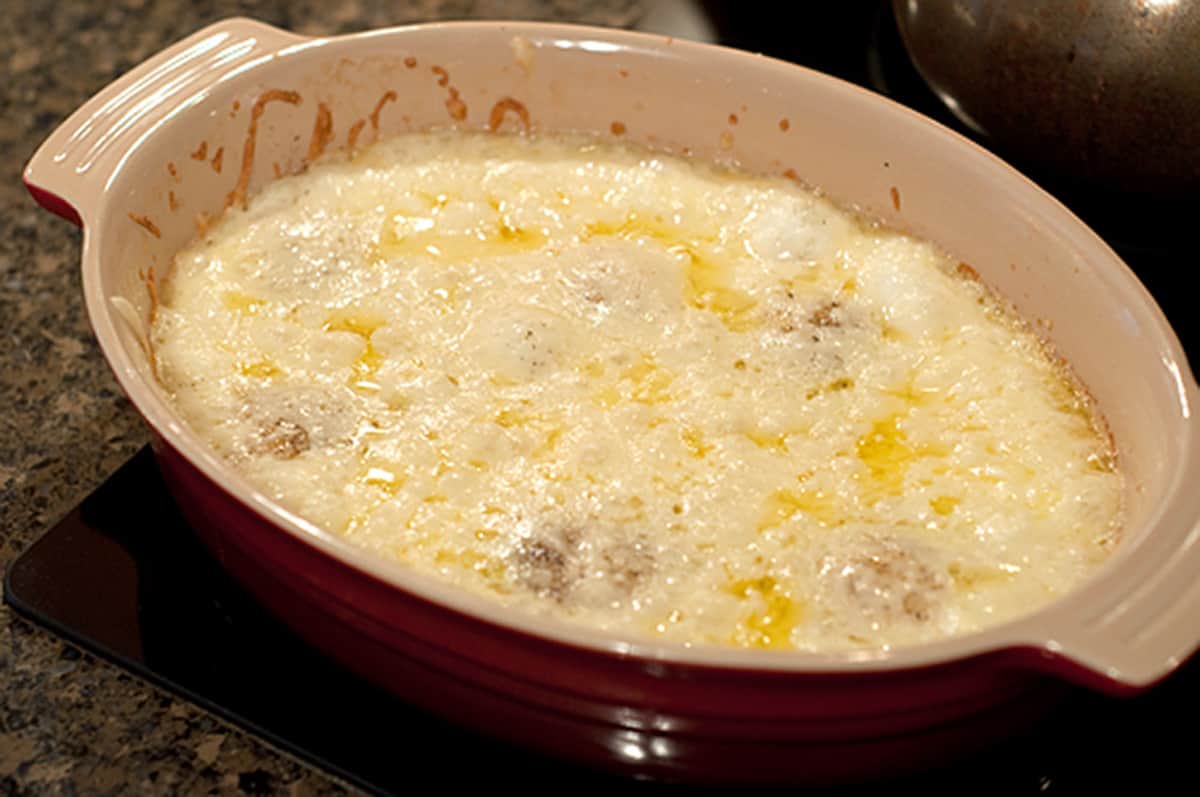 Baking dish of eggs and cheese after cooking.