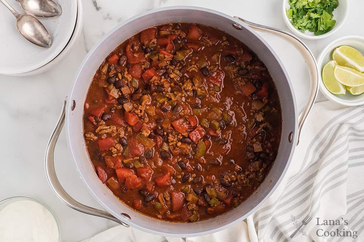 Finished chili in a white serving bowl.