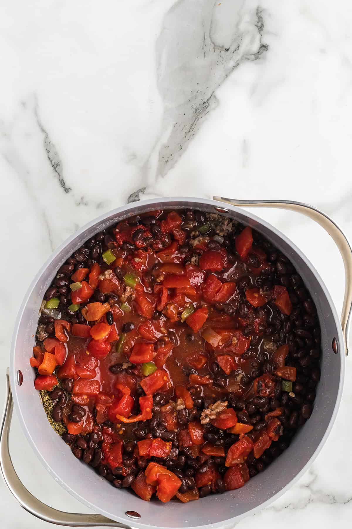 Tomatoes, beans, and remaining ingredients added to the mixture.