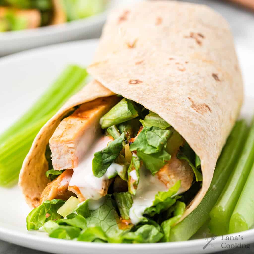 A buffalo chicken wrap showing the chicken and vegetables on the interior.
