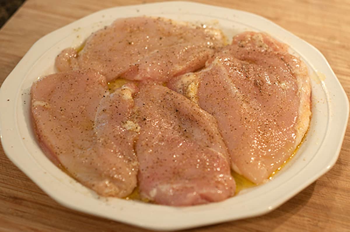 Seasoned chicken breasts on a dinner plate.