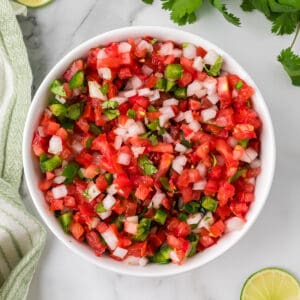 Finished pico de gallo in a white serving bowl.