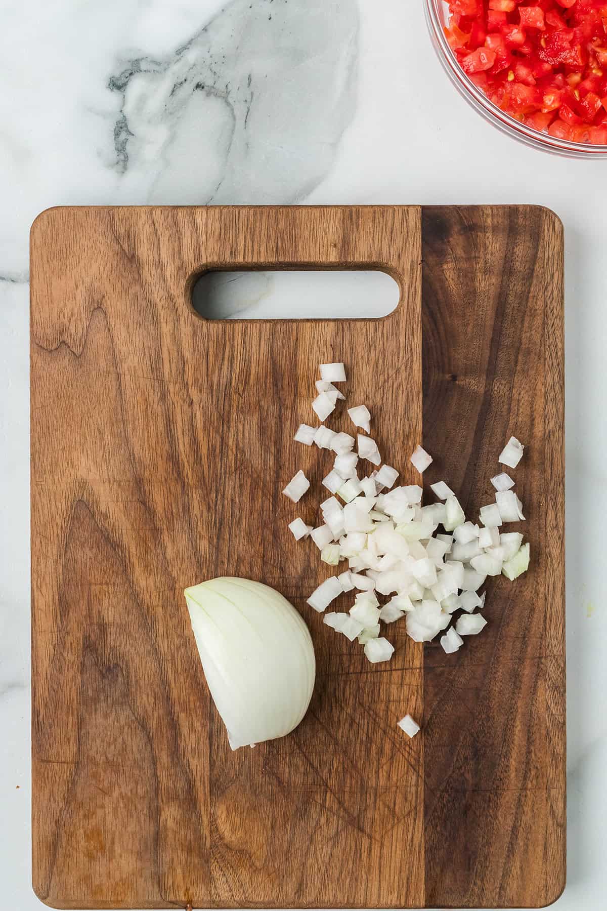 Chopped onion on a wooden board.