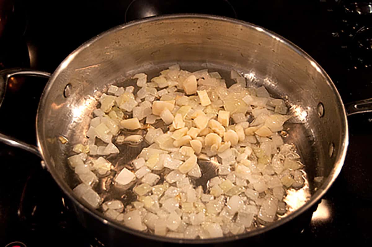 Garlic and onions sauteeing in a skillet.