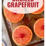 Four broiled grapefruit halves, each topped with a cherry, on a baking sheet with the text Broiled Grapefruit.