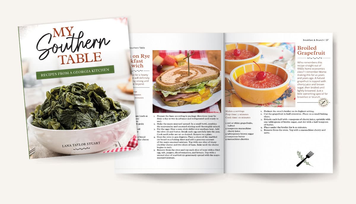 Cookbook cover and open pages showing recipes, a sandwich with potato wedges, and two bowls of broiled grapefruit.